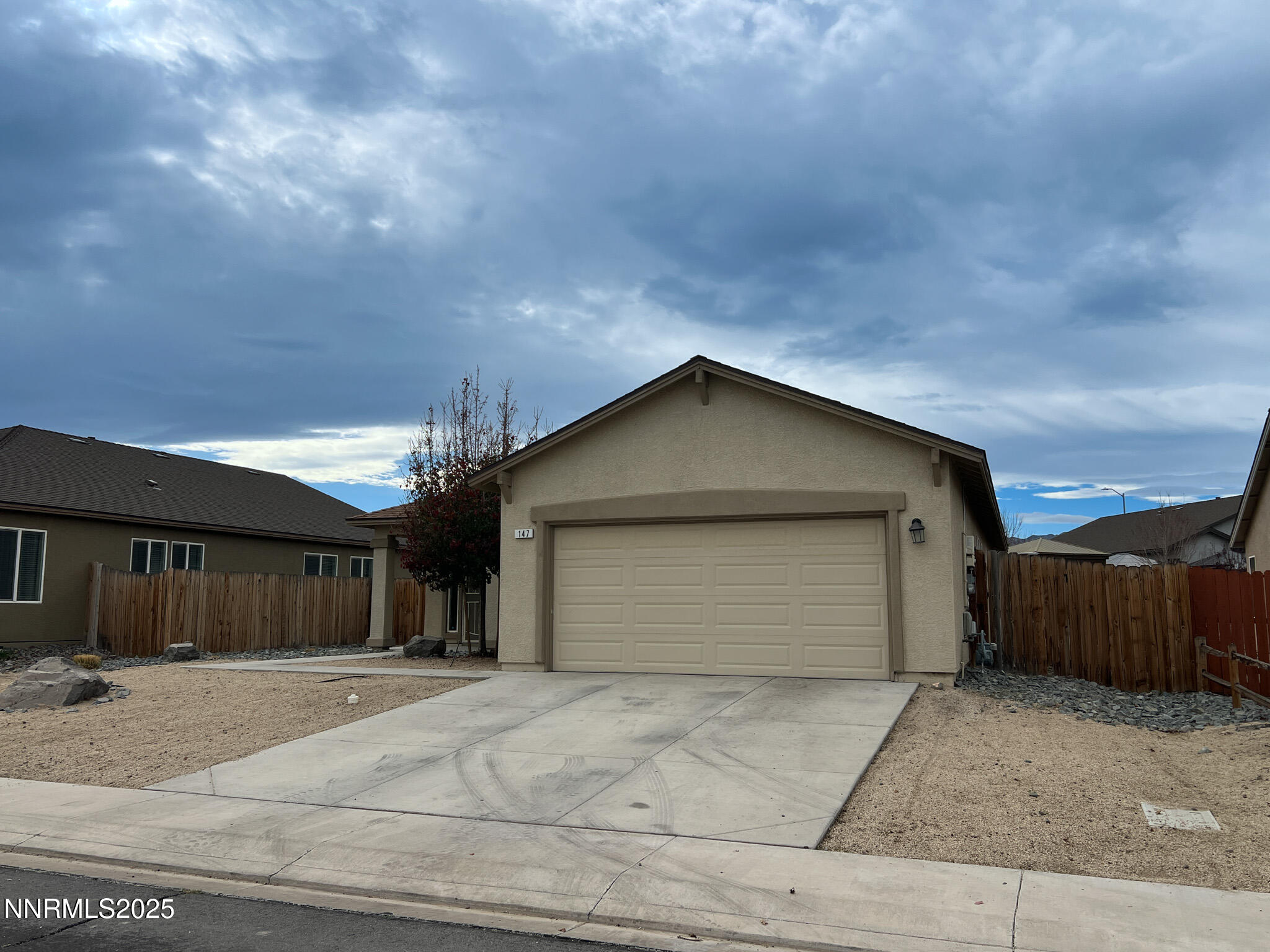 147 Walnut Drive Fernley, NV 89408 - Photo 28 of 31 a front view of a house with a yard and garage