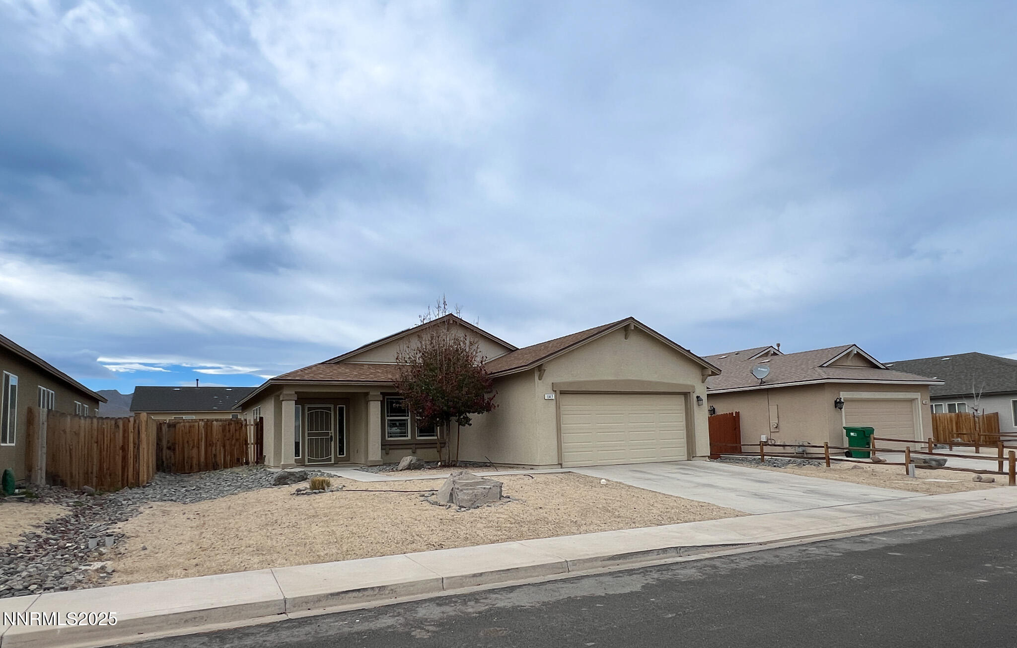 147 Walnut Drive Fernley, NV 89408 - Photo 29 of 31 a front view of a house with a yard and garage