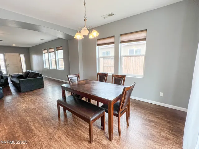 a view of a dining room with furniture and window