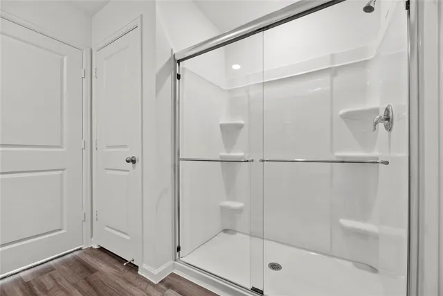 a bathroom with a glass shower door