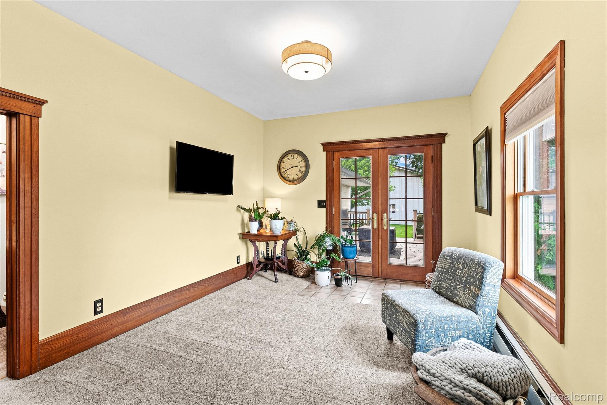 2971 Huron Line Road Cass City, MI 48726 - Photo 20 of 63 Carpeted room featuring a ceiling-mounted light fixture, wood trim, and a window with wood framing