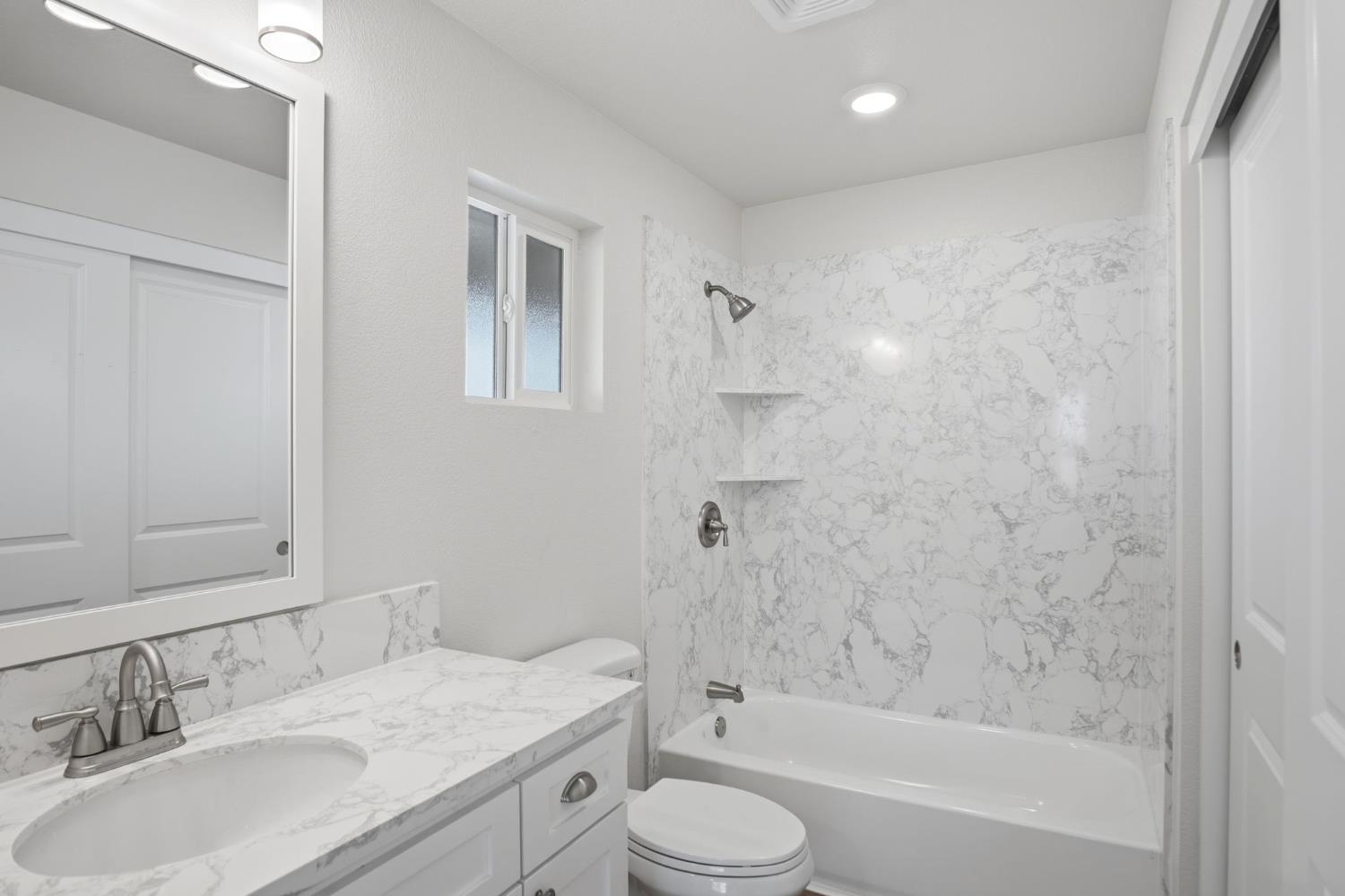 3447 Manchester Road Atwater, CA 95301 - Photo 20 of 31 a bathroom with a granite countertop sink toilet and shower