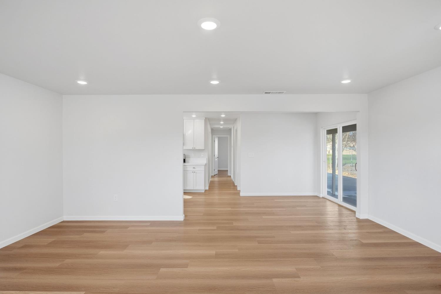 3447 Manchester Road Atwater, CA 95301 - Photo 8 of 31 a view of an empty room with wooden floor and a window