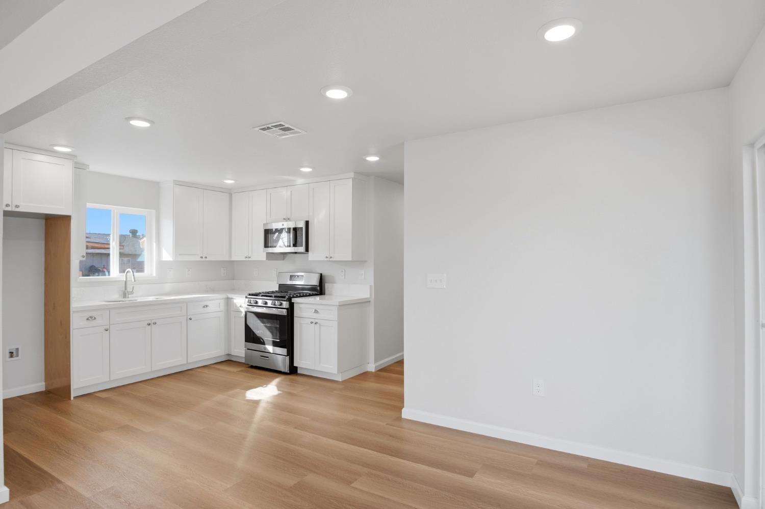 3447 Manchester Road Atwater, CA 95301 - Photo 9 of 31 a large kitchen with a refrigerator and a stove top oven