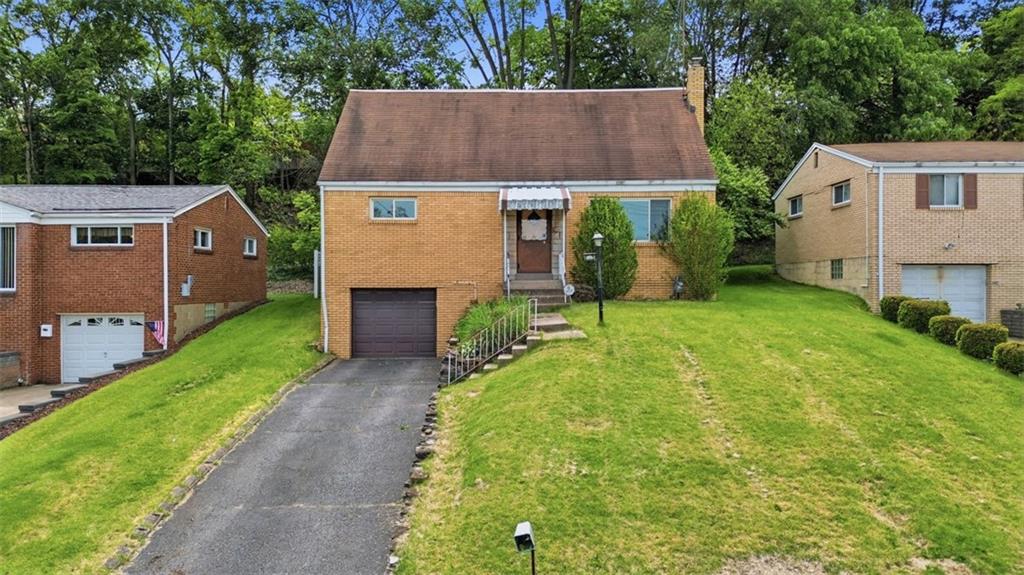 328 Ruthwood Avenue Pittsburgh, PA 15227 - Photo 1 of 32 a aerial view of a house next to a yard and large tree