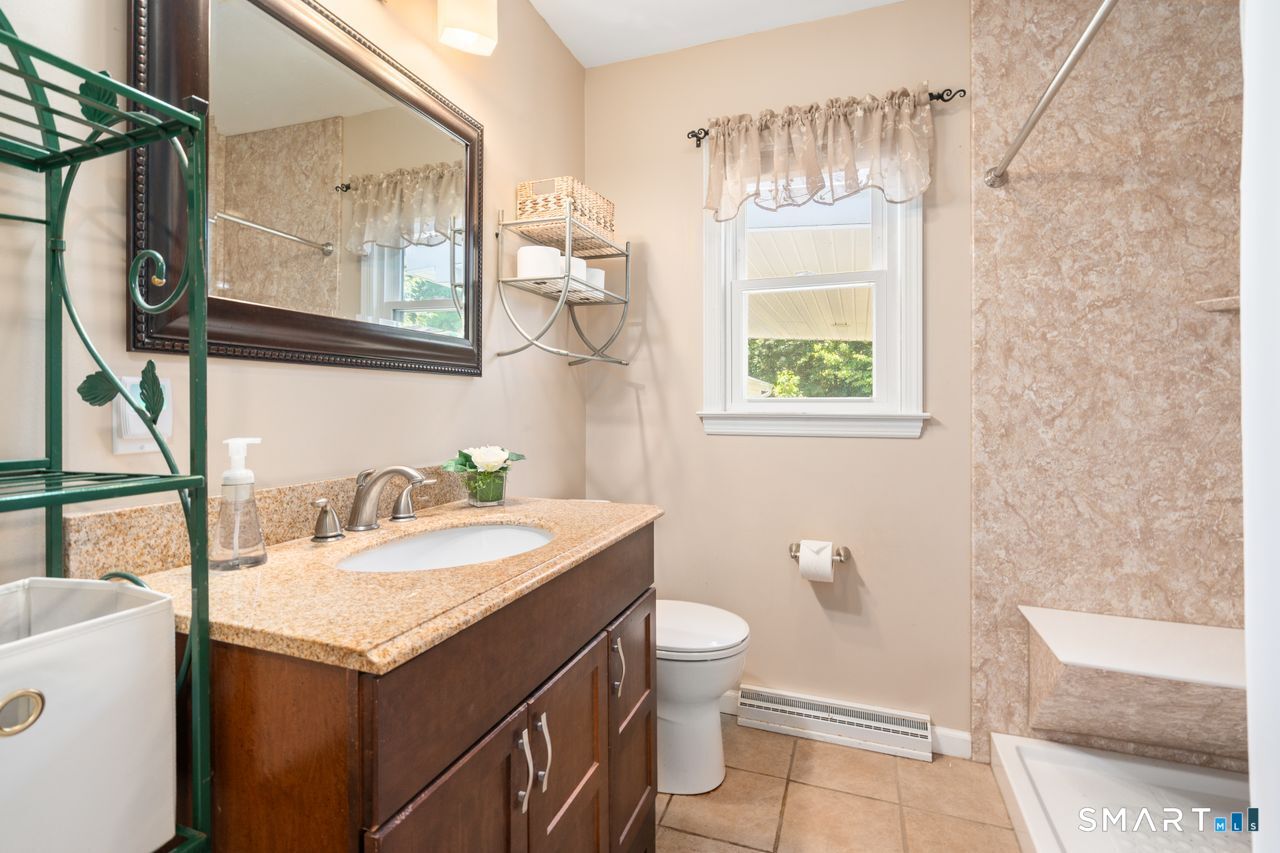 9 Stanton Road North Haven, CT 06473 - Photo 21 of 35 a bathroom with a granite countertop sink toilet and mirror