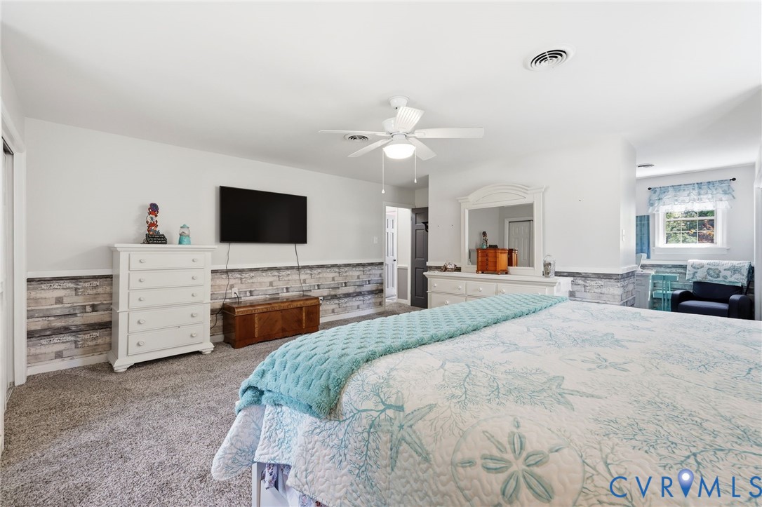 11200 Surry Road Chester, VA 23831 - Photo 24 of 48 a bed room with furniture and a flat screen tv