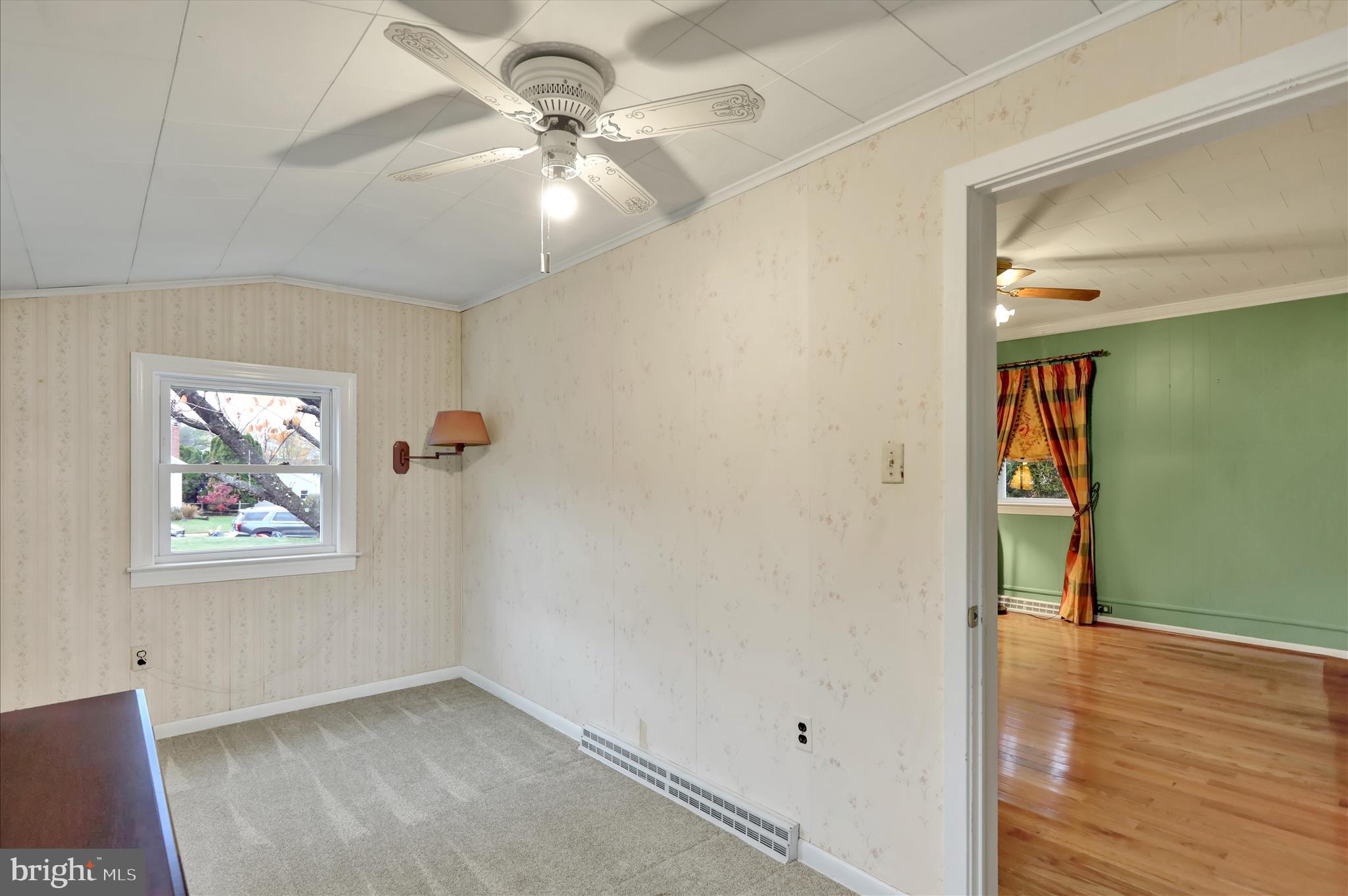 3429 Marion Street Reading, PA 19605 - Photo 13 of 23 an empty room with wooden floor chandelier fan and windows
