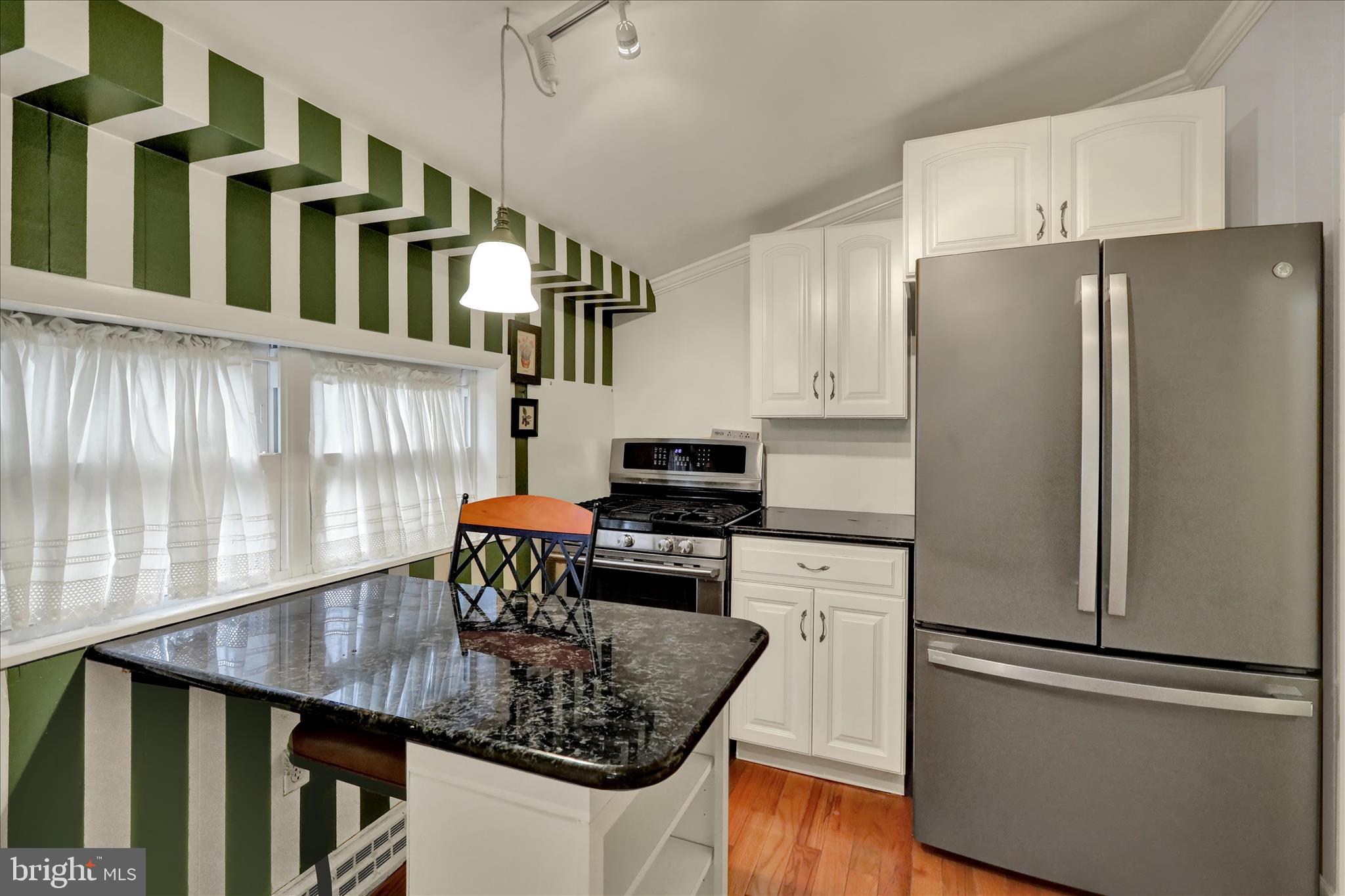 3429 Marion Street Reading, PA 19605 - Photo 20 of 23 a kitchen with stainless steel appliances granite countertop a refrigerator a stove a sink dishwasher and white cabinets with wooden floor