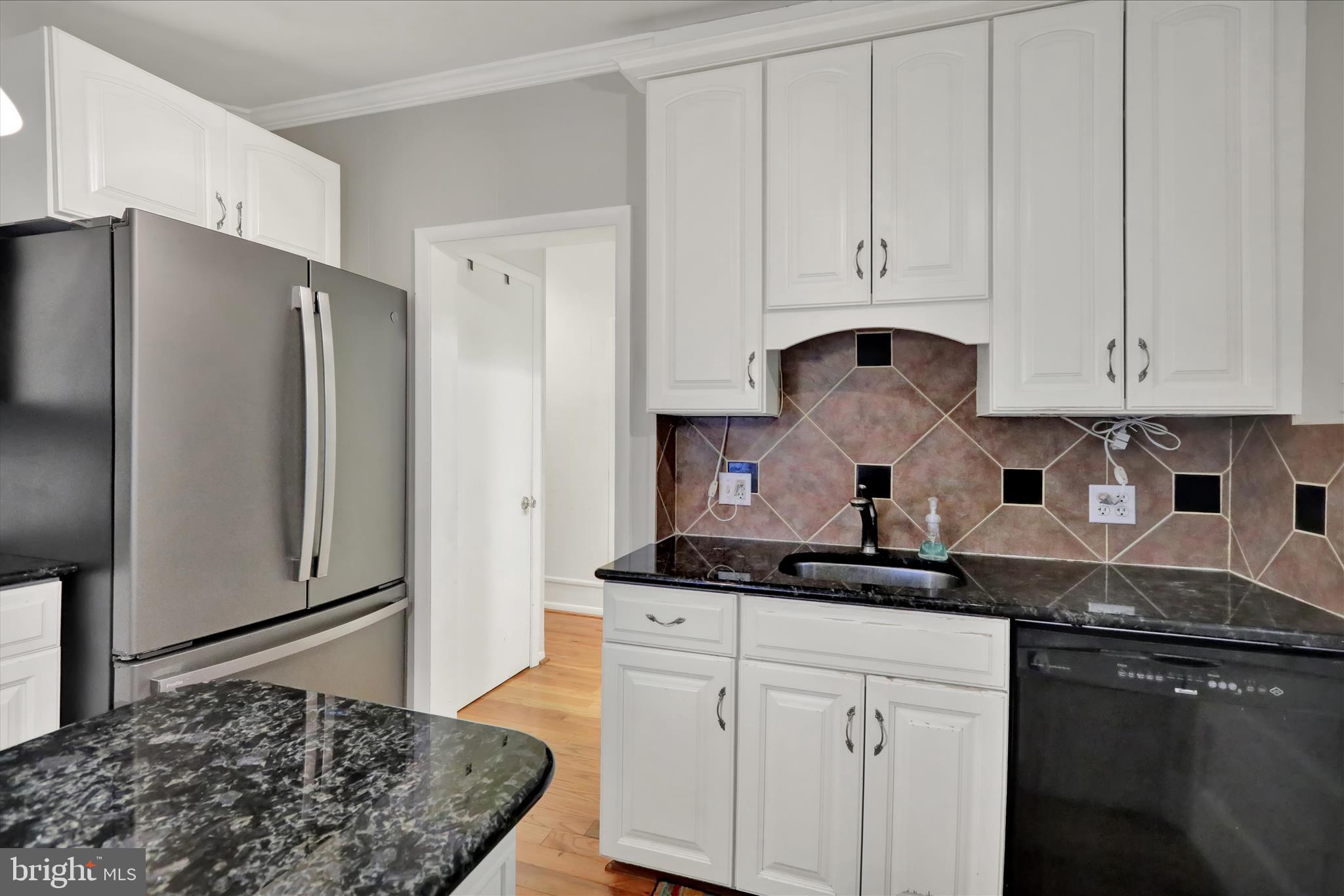 3429 Marion Street Reading, PA 19605 - Photo 21 of 23 a kitchen with stainless steel appliances granite countertop a refrigerator and white cabinets