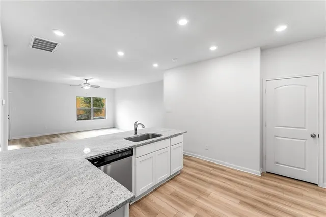 a kitchen with a sink and a stove top oven