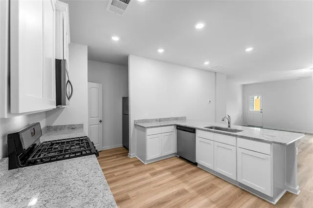 a kitchen with a sink and cabinets