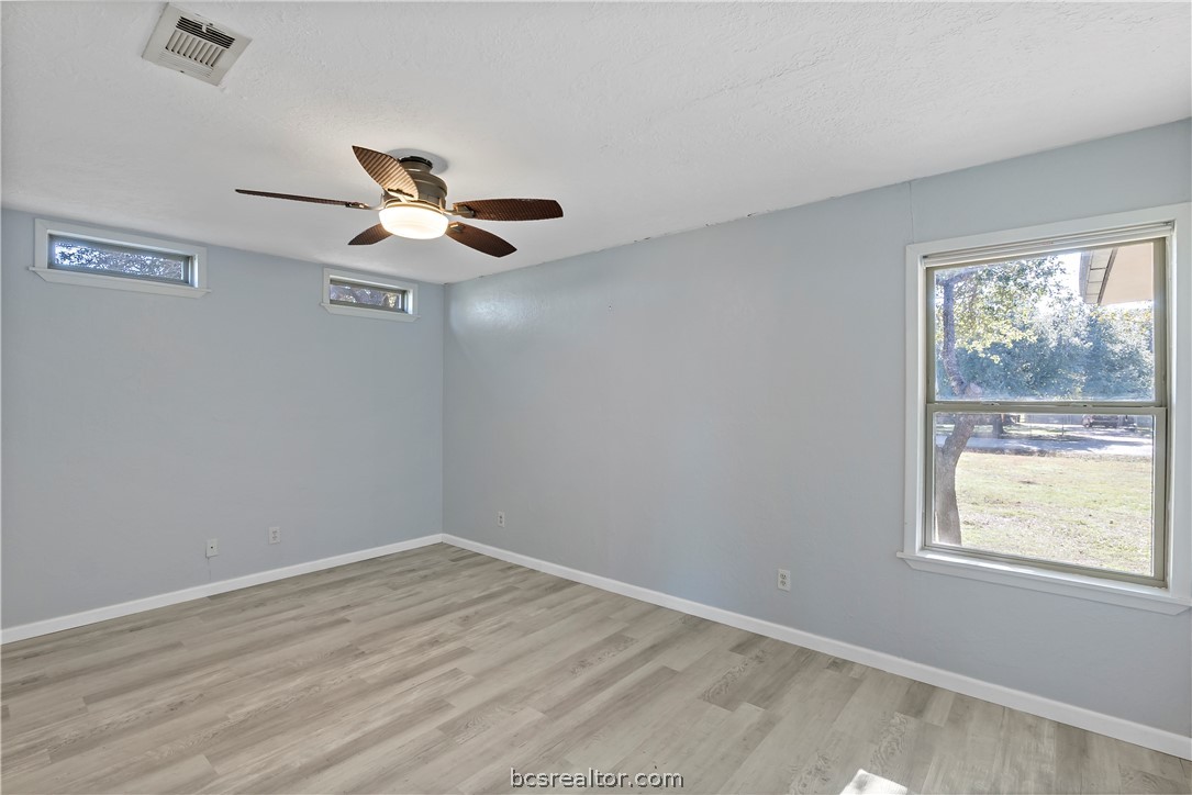 8801 Old Reliance Road Bryan, TX 77808 - Photo 19 of 24 Spacious 3rd bedroom with neutral flooring and multiple windows for natural light.