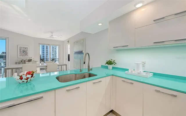 a kitchen with sink refrigerator and cabinets