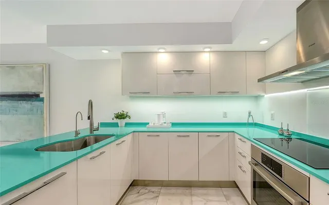 a kitchen with lots of counter space and sink