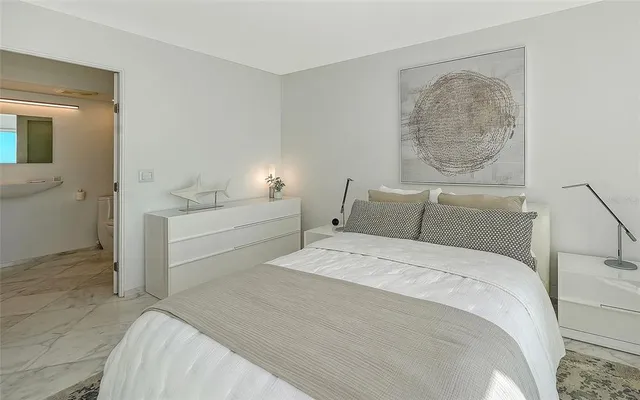 a bedroom with a bed and a painting on the wall