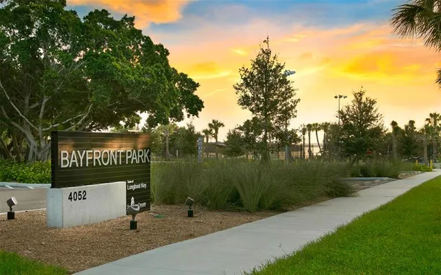 a sign board with a park area