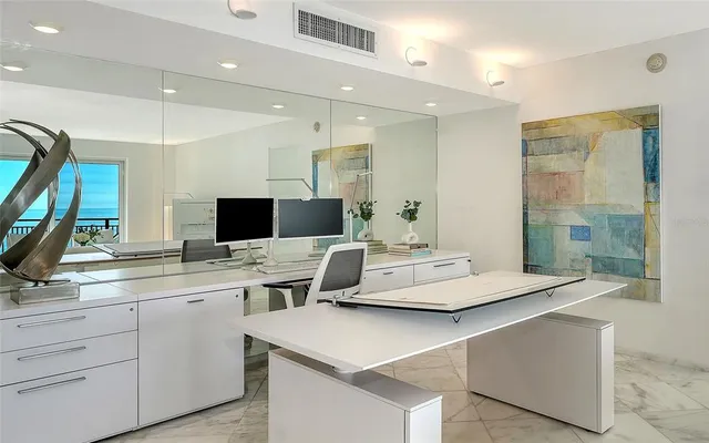 a living room with stainless steel appliances kitchen island a flat screen tv and a view of living room