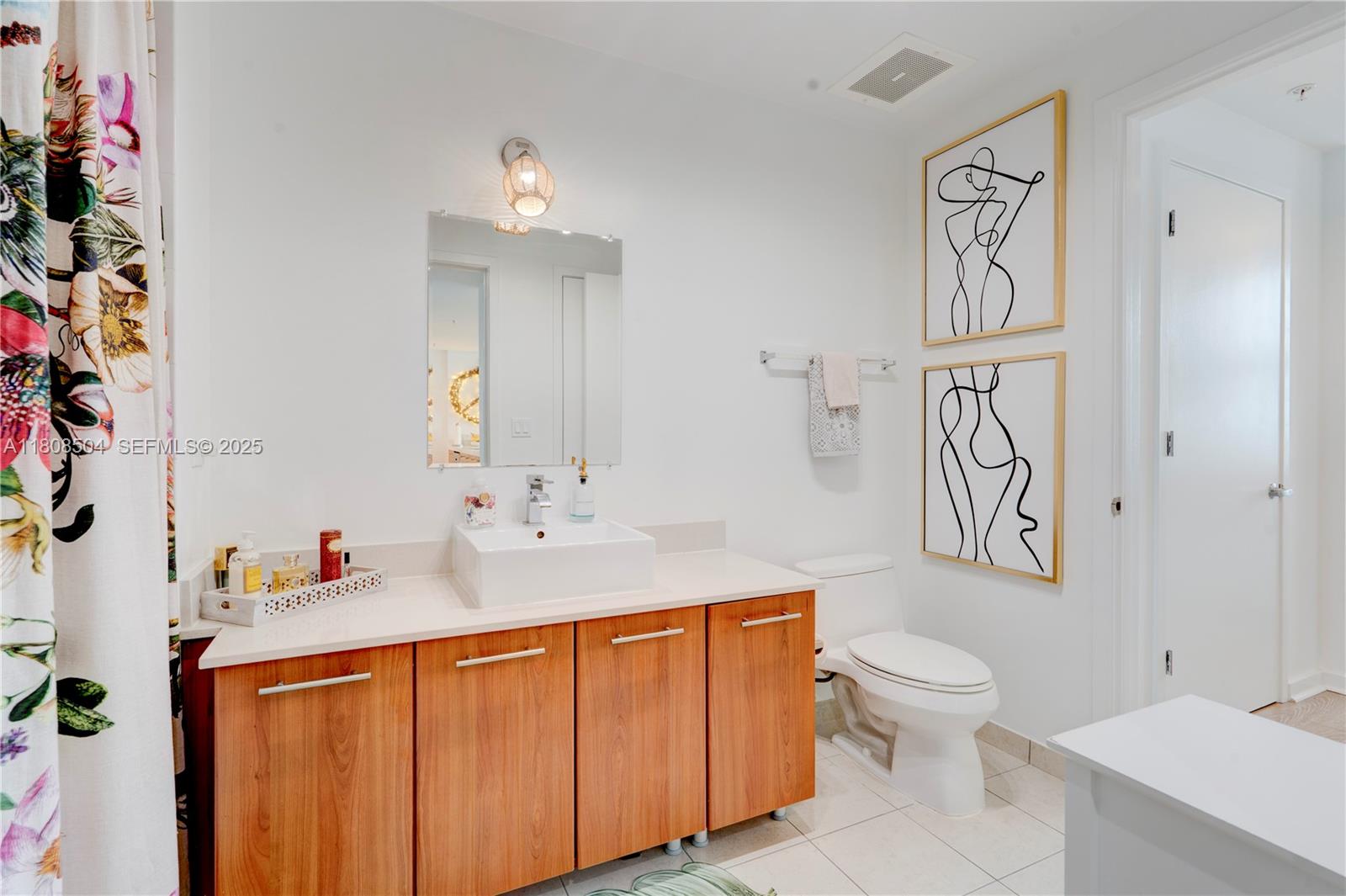 3301 Northeast 1st Avenue, Unit H2304 Miami, FL 33137 - Photo 14 of 27 a bathroom with a sink a toilet and a mirror