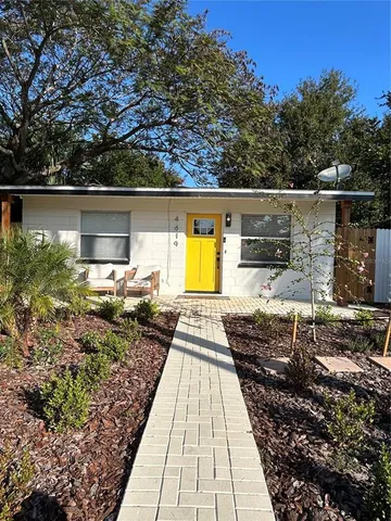 a view of a backyard with pathway