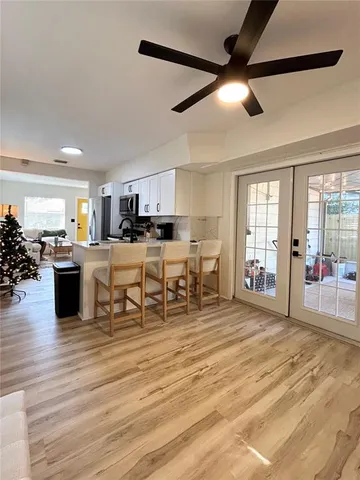 a room with stainless steel appliances kitchen island granite countertop a stove and cabinets