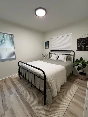 a bedroom with bed and a window