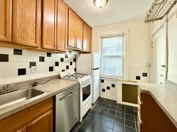 a kitchen with stainless steel appliances a stove a sink and a microwave