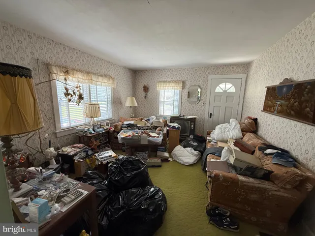 a living room with lots of furniture and a window