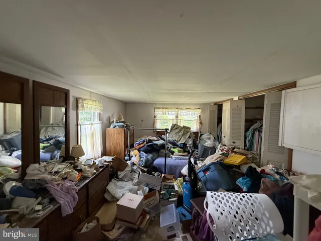 a living room with furniture fireplace and large windows