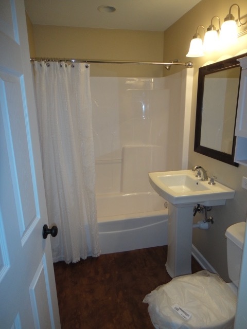 5711 Willow Springs Road Countryside, IL 60525 - Photo 14 of 17 a bathroom with a sink a toilet a mirror and shower