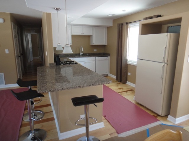 5711 Willow Springs Road Countryside, IL 60525 - Photo 6 of 17 a kitchen with stainless steel appliances granite countertop a refrigerator and a stove