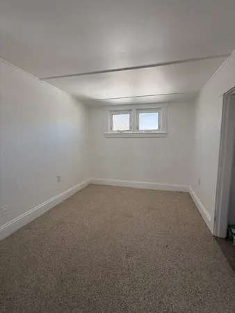 an empty room with a empty space and windows