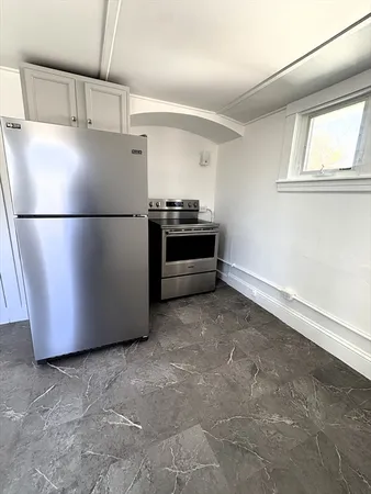 a white refrigerator freezer sitting in a kitchen