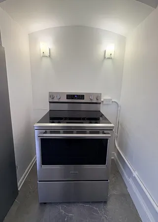a stove top oven sitting inside of a kitchen