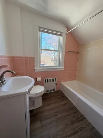 a bathroom with a sink a toilet and bathtub