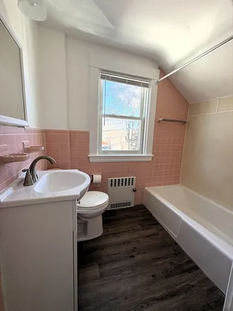 a bathroom with a sink a toilet and bathtub