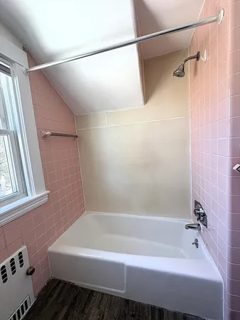 a bathroom with a bathtub and a shower