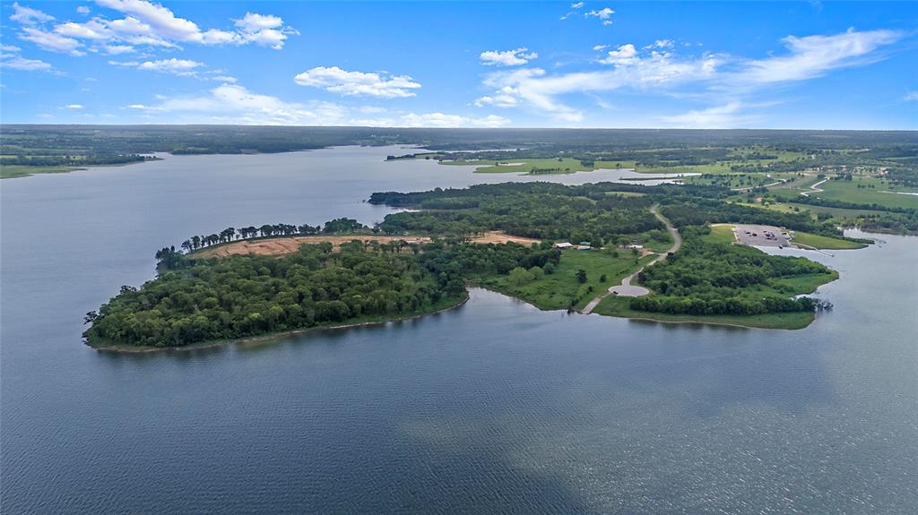 12408 Fm-1396, Unit B Windom, TX 75492 - Photo 3 of 3 a view of a lake with a yard and mountain in the background
