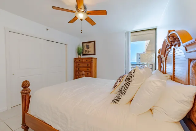 a bedroom with a bed and a ceiling fan