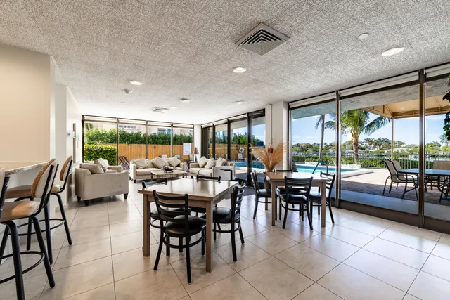 a view of a hallway and a livingroom with furniture
