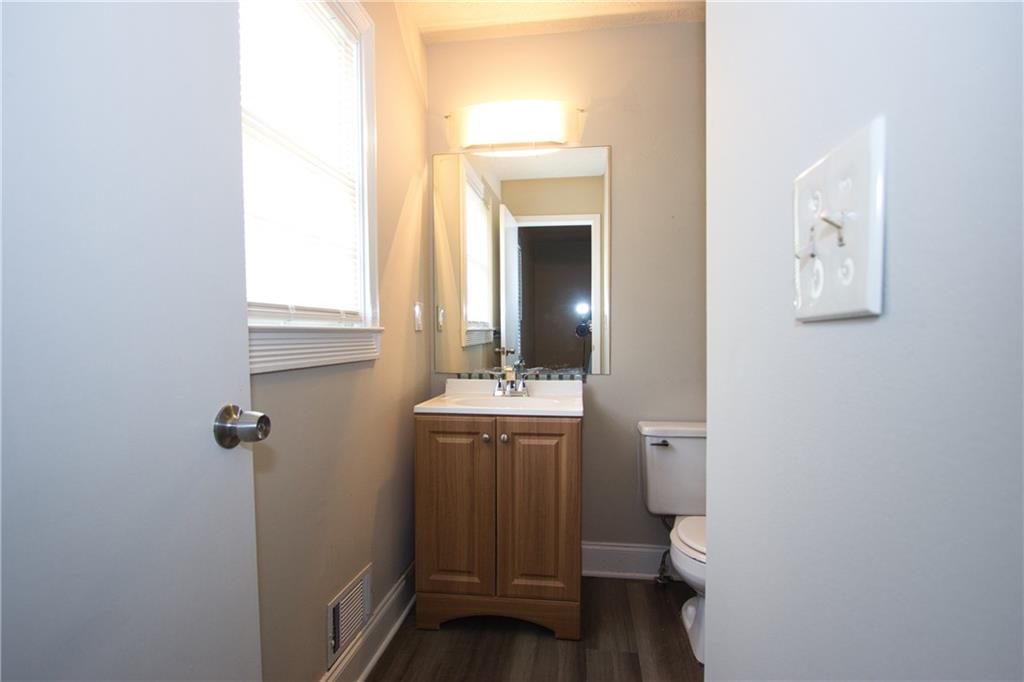 4541 Center Hill Church Road Loganville, GA 30052 - Photo 12 of 25 a bathroom with a granite countertop sink and a toilet