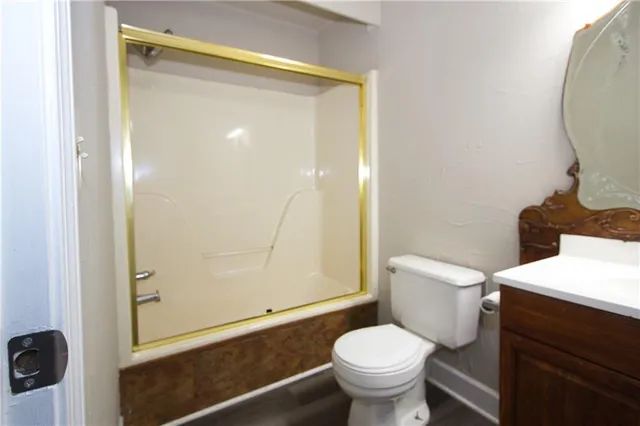 a white toilet sitting next to a bathroom sink