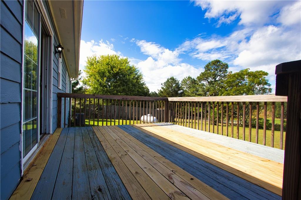 4541 Center Hill Church Road Loganville, GA 30052 - Photo 23 of 25 a balcony with wooden floor and fence