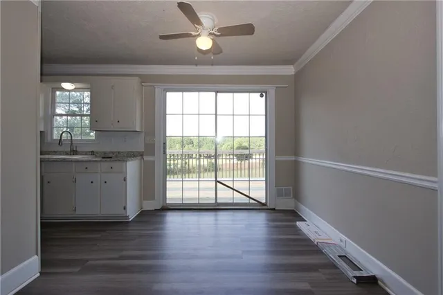 a view of a kitchen with a sink and a window