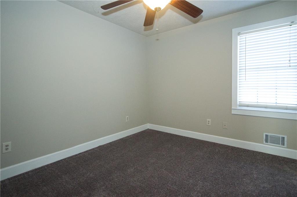 4541 Center Hill Church Road Loganville, GA 30052 - Photo 10 of 25 an empty room with a window and a fan