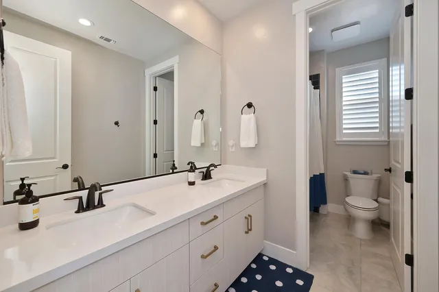 a bathroom with a toilet sink and mirror