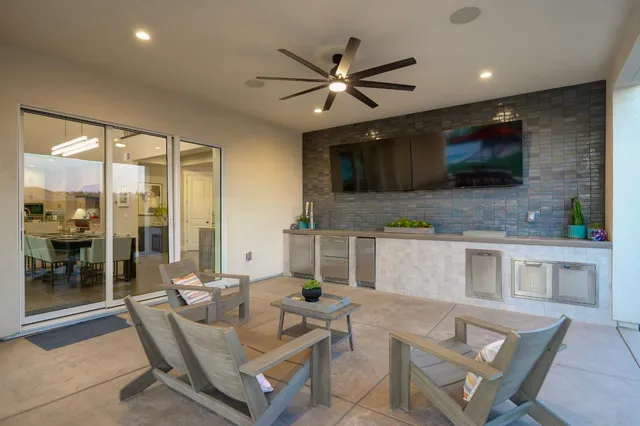 a kitchen with a table and chairs in front of it