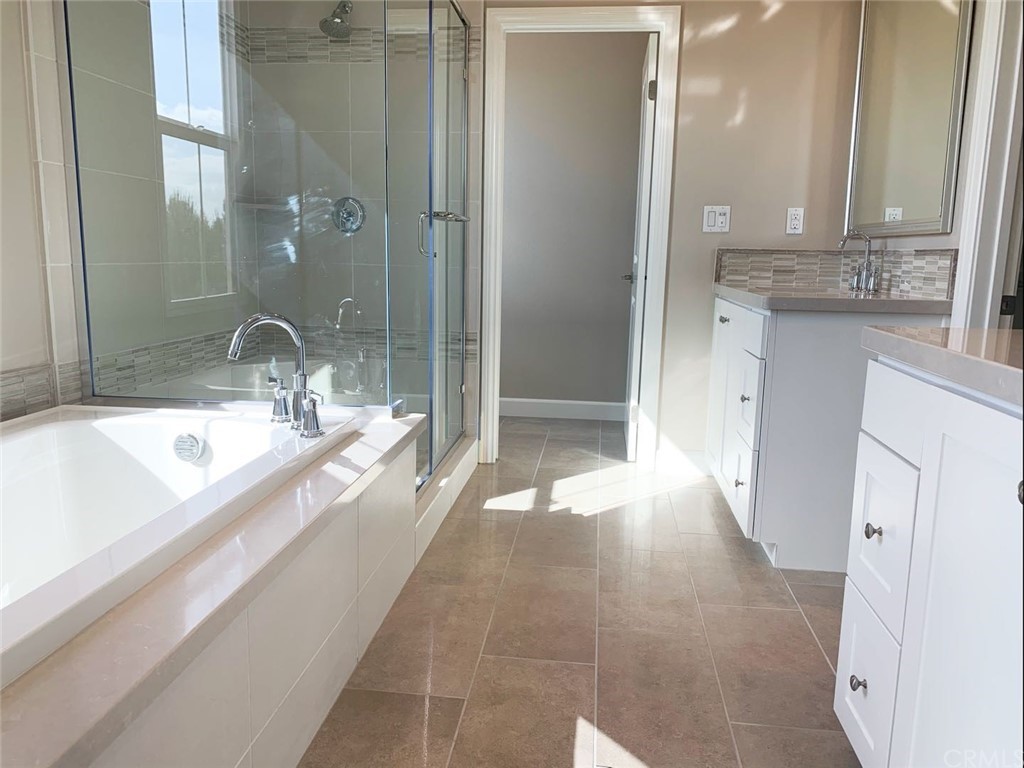 68 Singer Irvine, CA 92620 - Photo 10 of 12 a bathroom with a granite countertop sink a mirror and shower