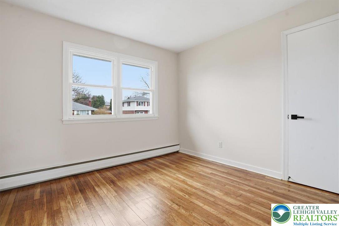 3120 Hilly Road Bethlehem, PA 18017 - Photo 16 of 37 a view of an empty room with wooden floor and a window