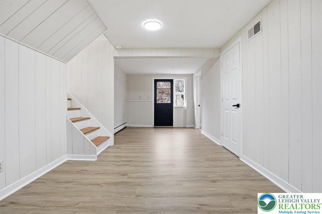 3120 Hilly Road Bethlehem, PA 18017 - Photo 21 of 37 a view of an empty room with wooden floor and stairs